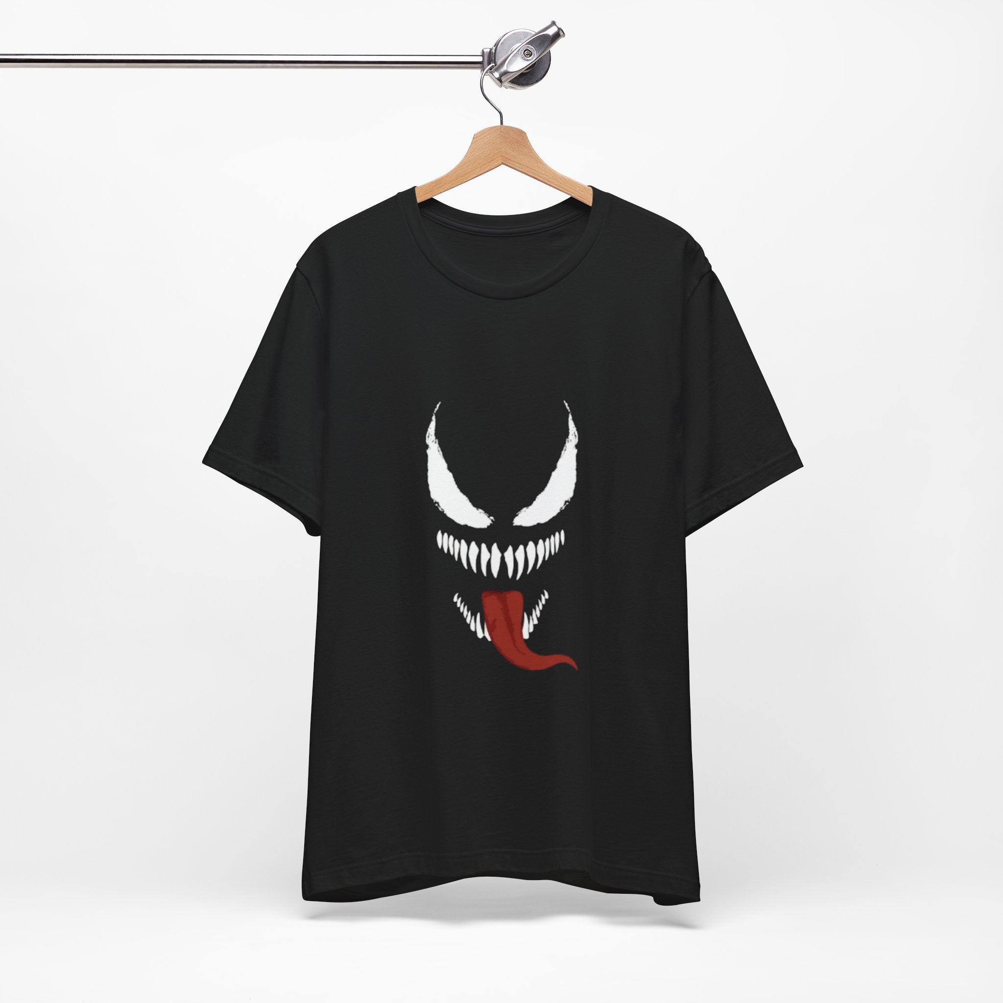 Black t-shirt with a graphic design on a hanger against a white background