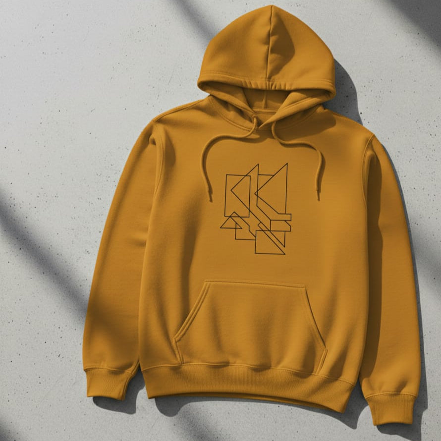 Yellow hoodie with a black geometric design on a gray surface
