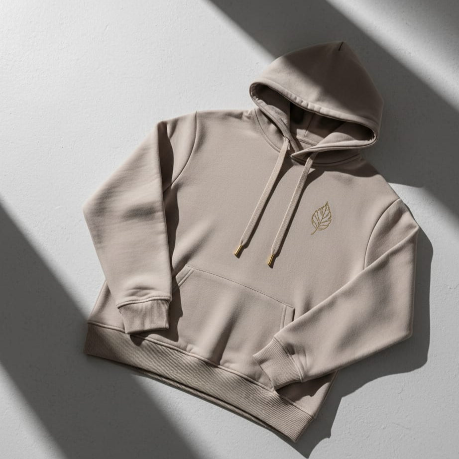 Beige hoodie with a logo on a light gray background